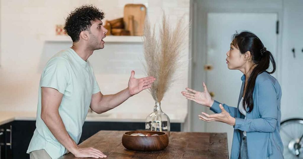 Pareja discutiendo en la cocina de su hogar